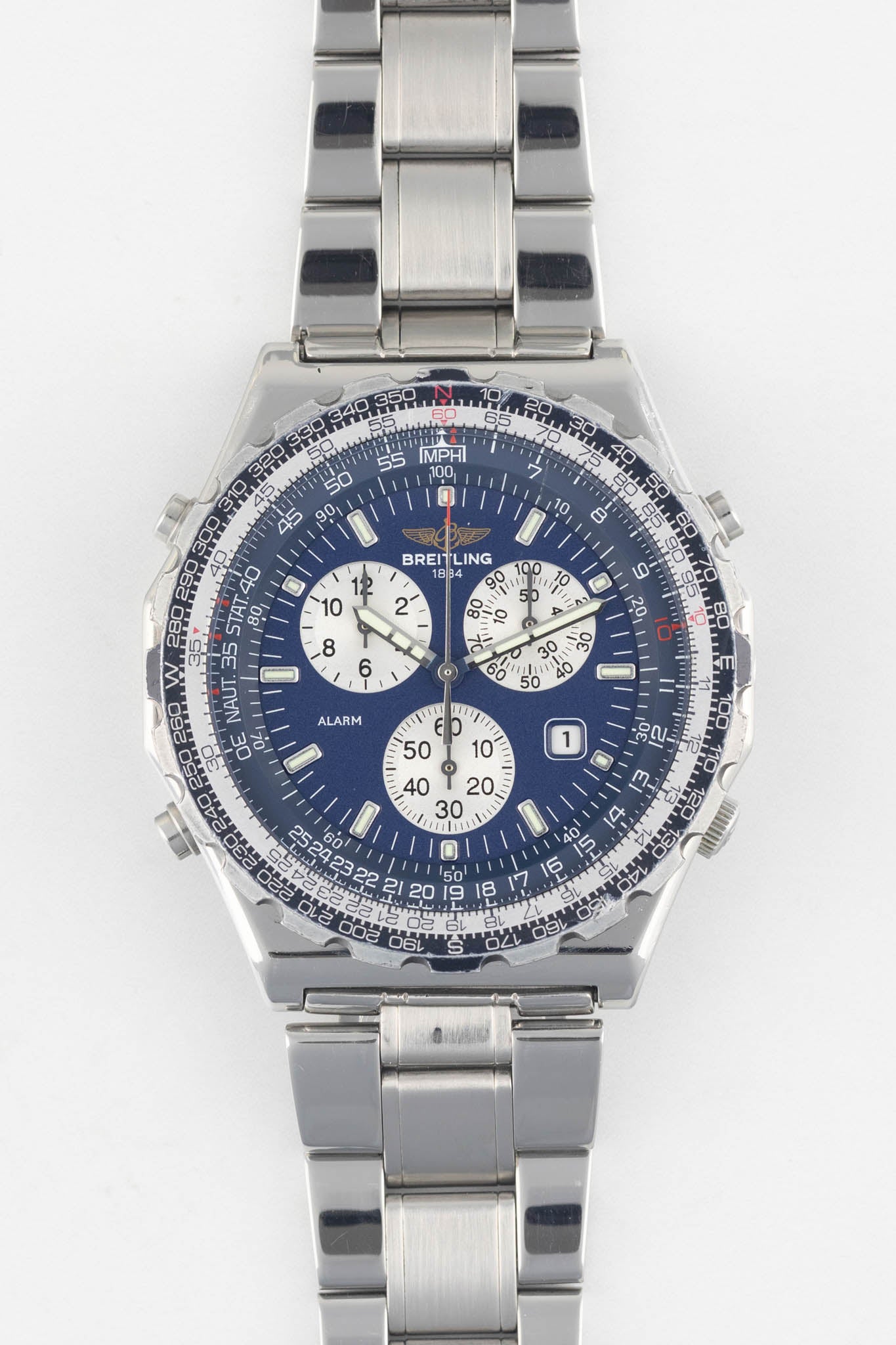 A front-facing studio shot of a Breitling Jupiter Pilot Quartz watch on a white background, showing the blue dial and stainless steel link bracelet.