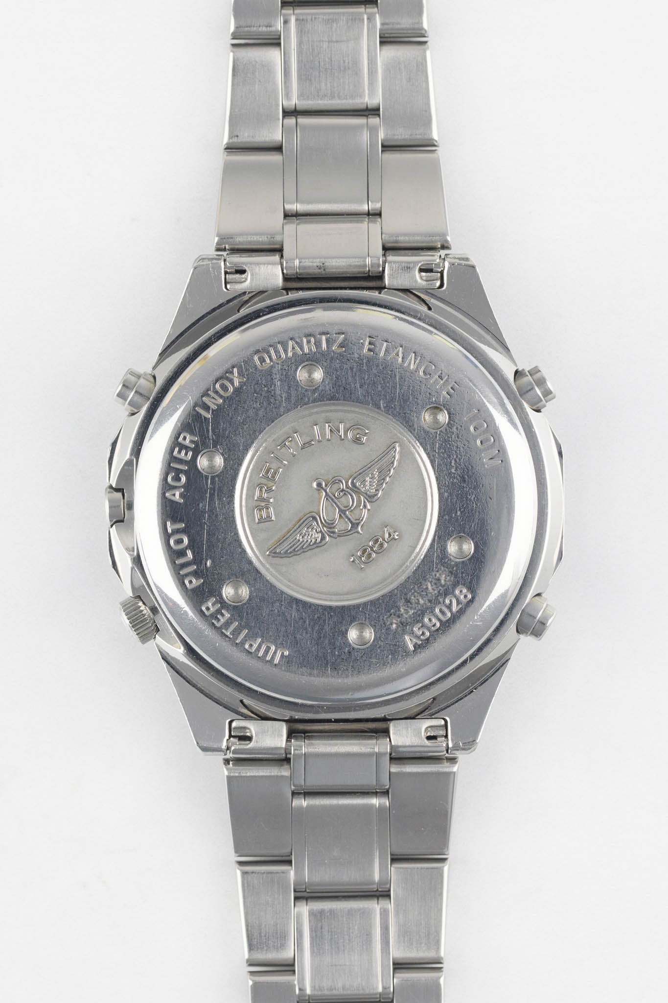 A direct view of the stainless steel case back of a Breitling Jupiter Pilot watch, featuring the engraved Breitling wings logo and model reference number A59028.
