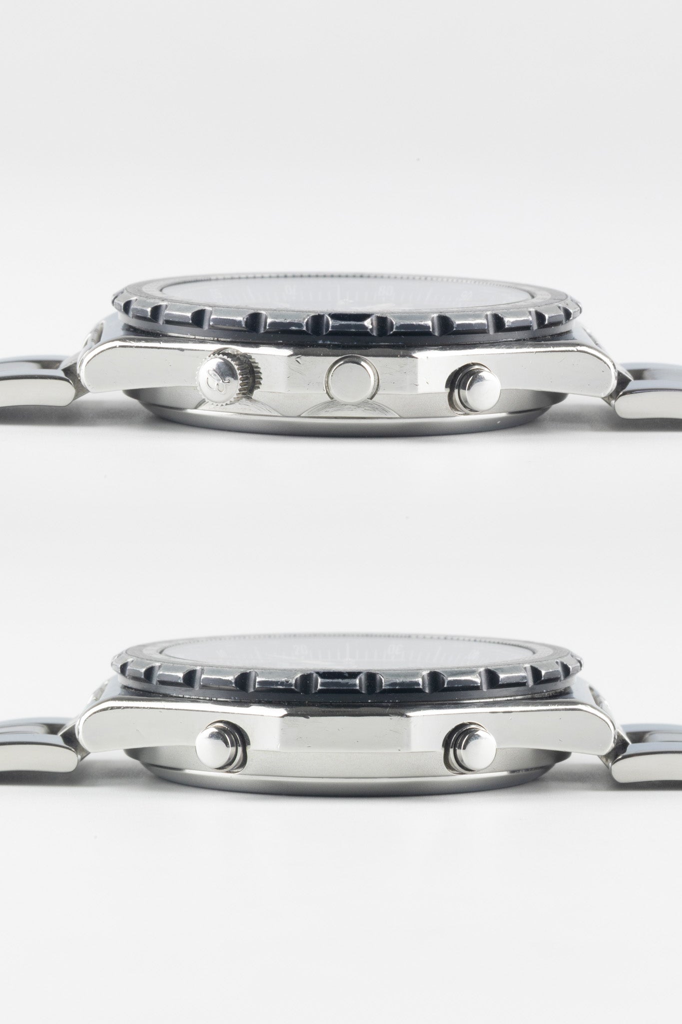 Two horizontal side-profile views of a stainless steel Breitling Jupiter Pilot watch case, showing the crown, chronograph pushers, and the textured edge of the rotating bezel.