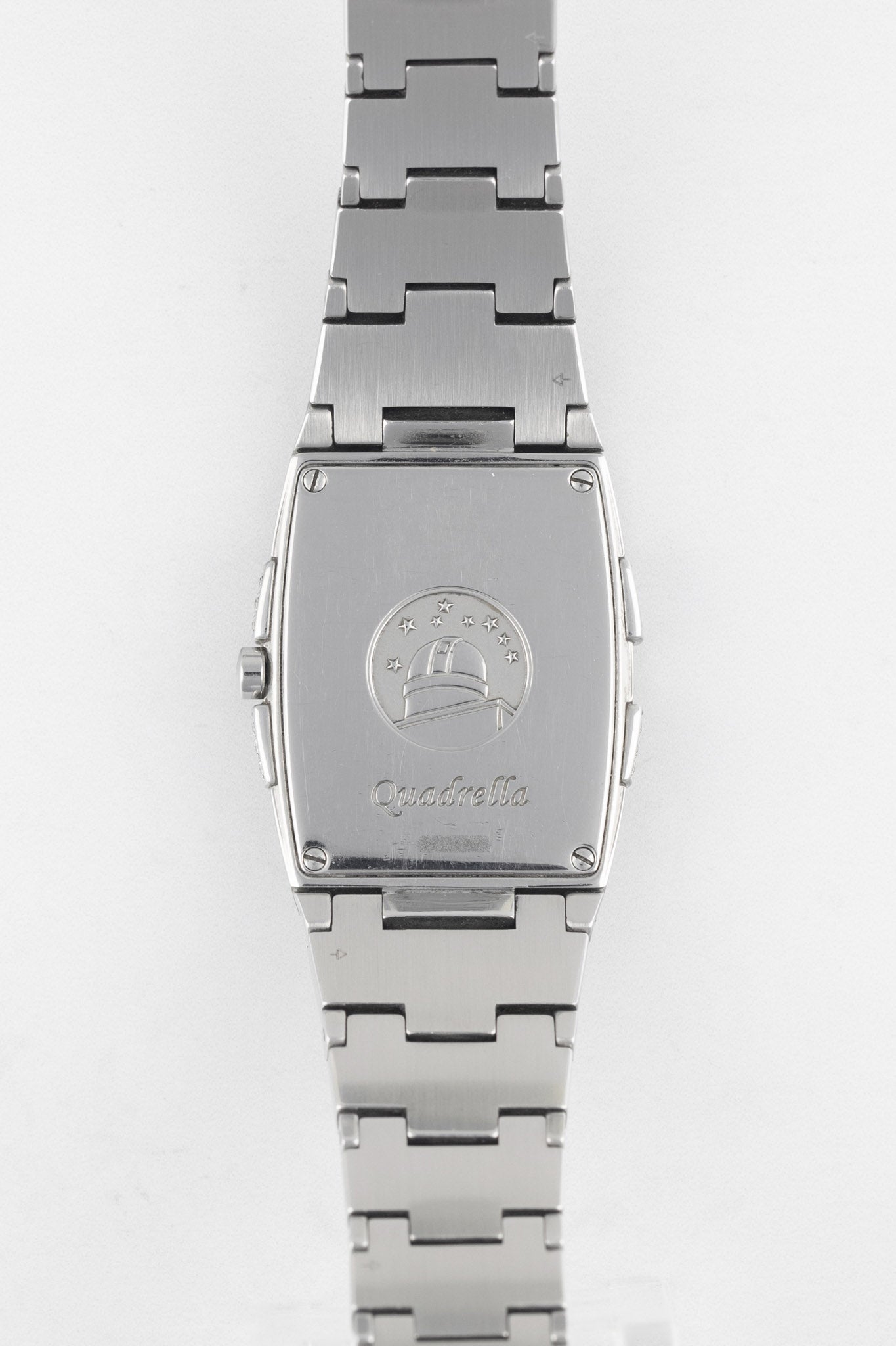 A direct view of the rectangular stainless steel case back, engraved with the "Quadrella" script and the Constellation observatory emblem.