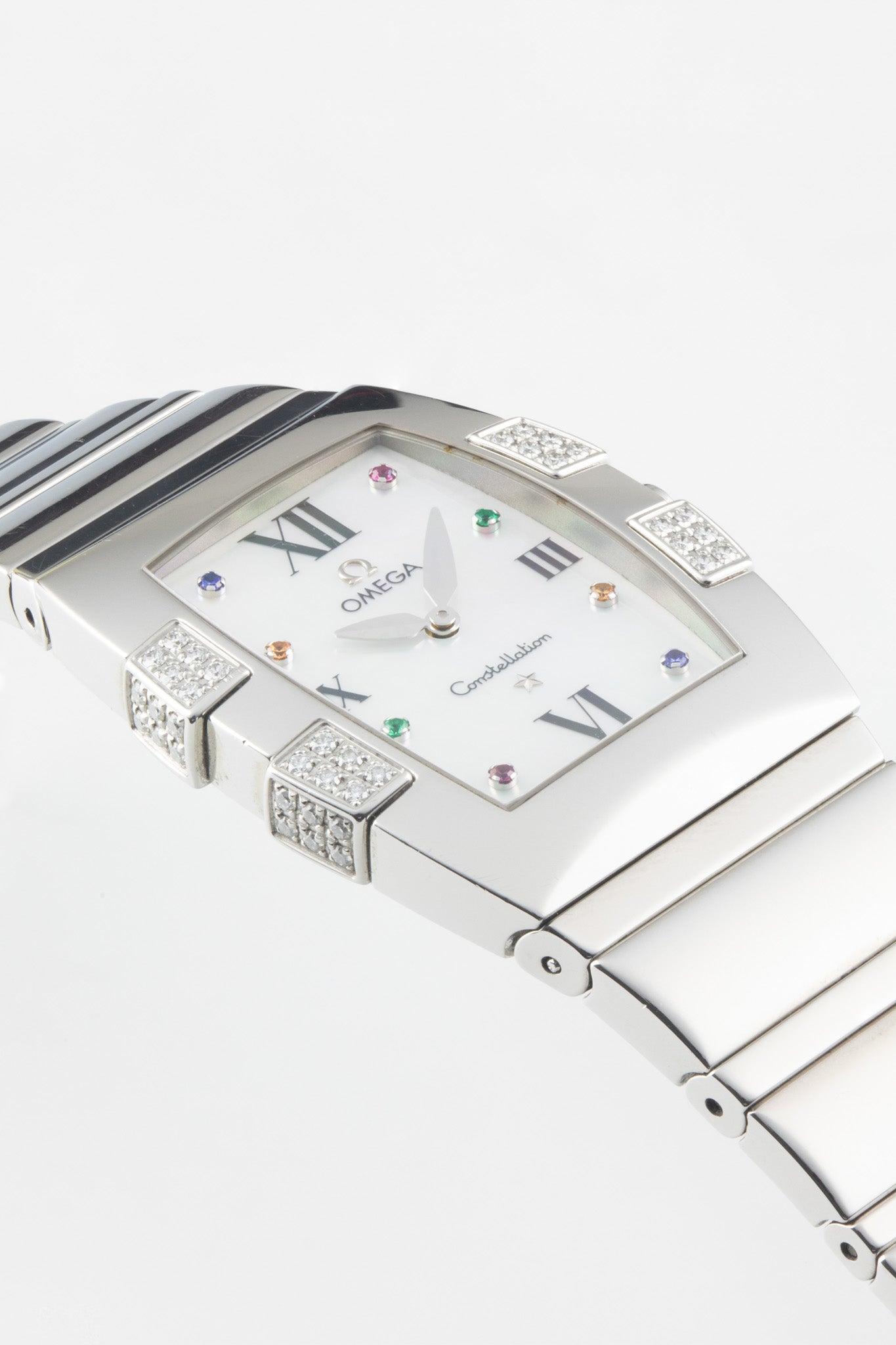 A close-up, angled view highlighting the iridescent mother-of-pearl dial, the silver-tone hands, and the intricate diamond setting on the side of the polished case.