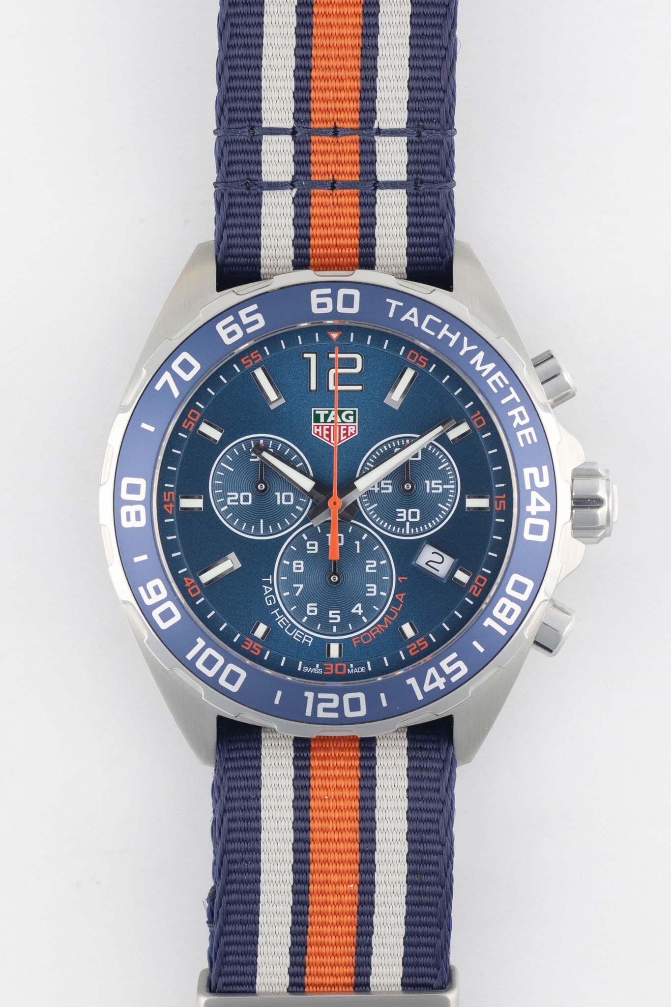 A clear, front-facing studio shot on a white background showing the blue sunray dial, three chronograph sub-dials, and the iconic Gulf logo above the 6 o'clock position.